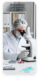 Lab researchers examining samples under a microscope during a clinical research study